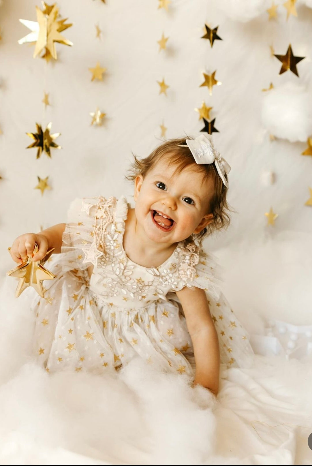 Child in a star-themed room with gold stars on a white background