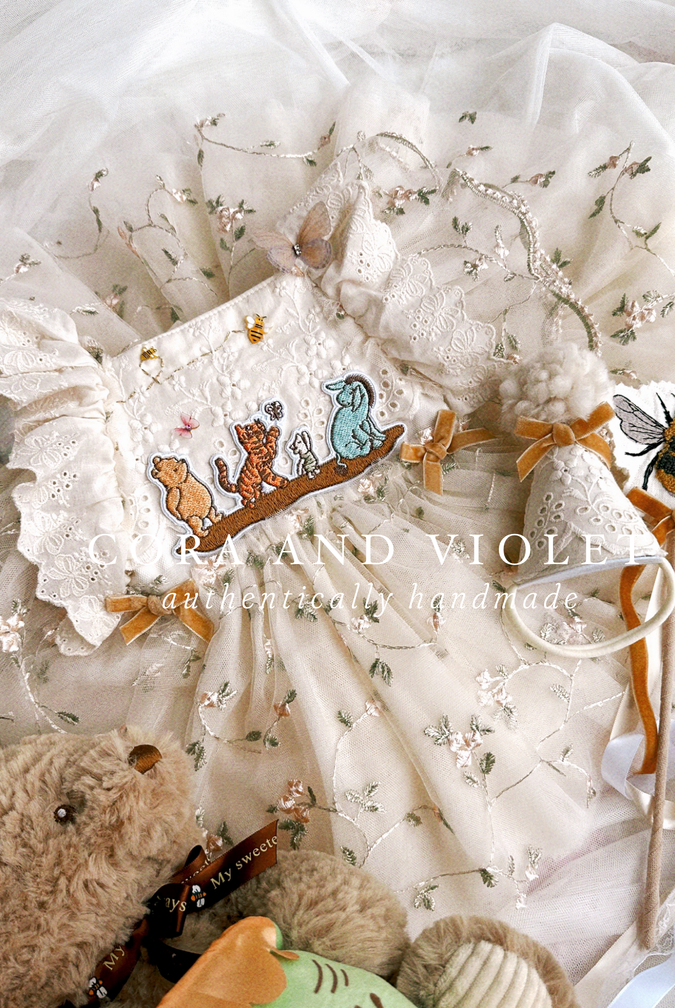 The Winnie Heirloom by Cora and Violet, a handmade Winnie the Pooh inspired birthday artisan-stitched rosebuds and hand-applied butterflies on a luxury classic pooh milestone gown.