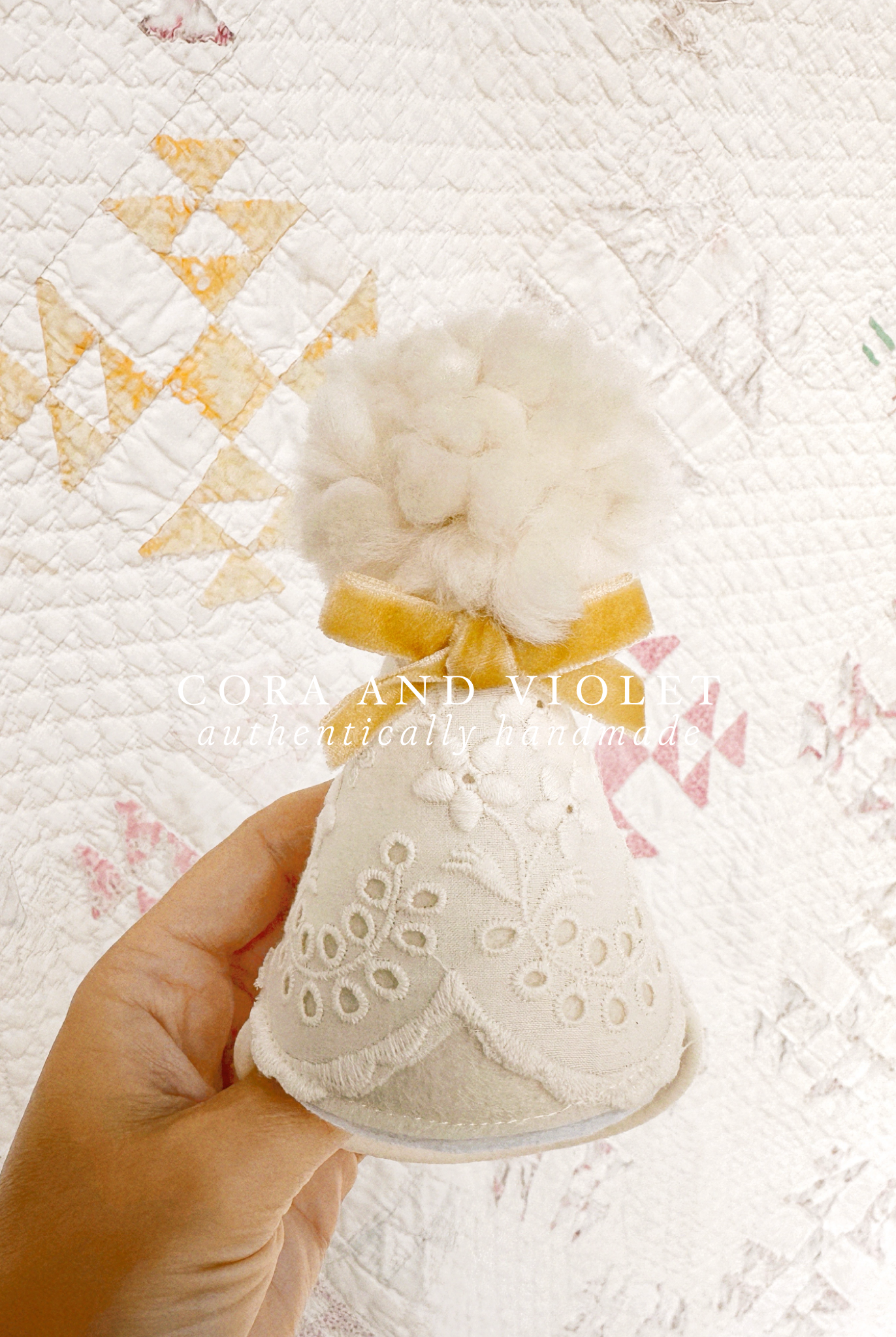 Close-up of vintage-style embroidered lace and hand-tied bow on a luxury heirloom party hat. cora and violet party hat first birthday accessories baby girl