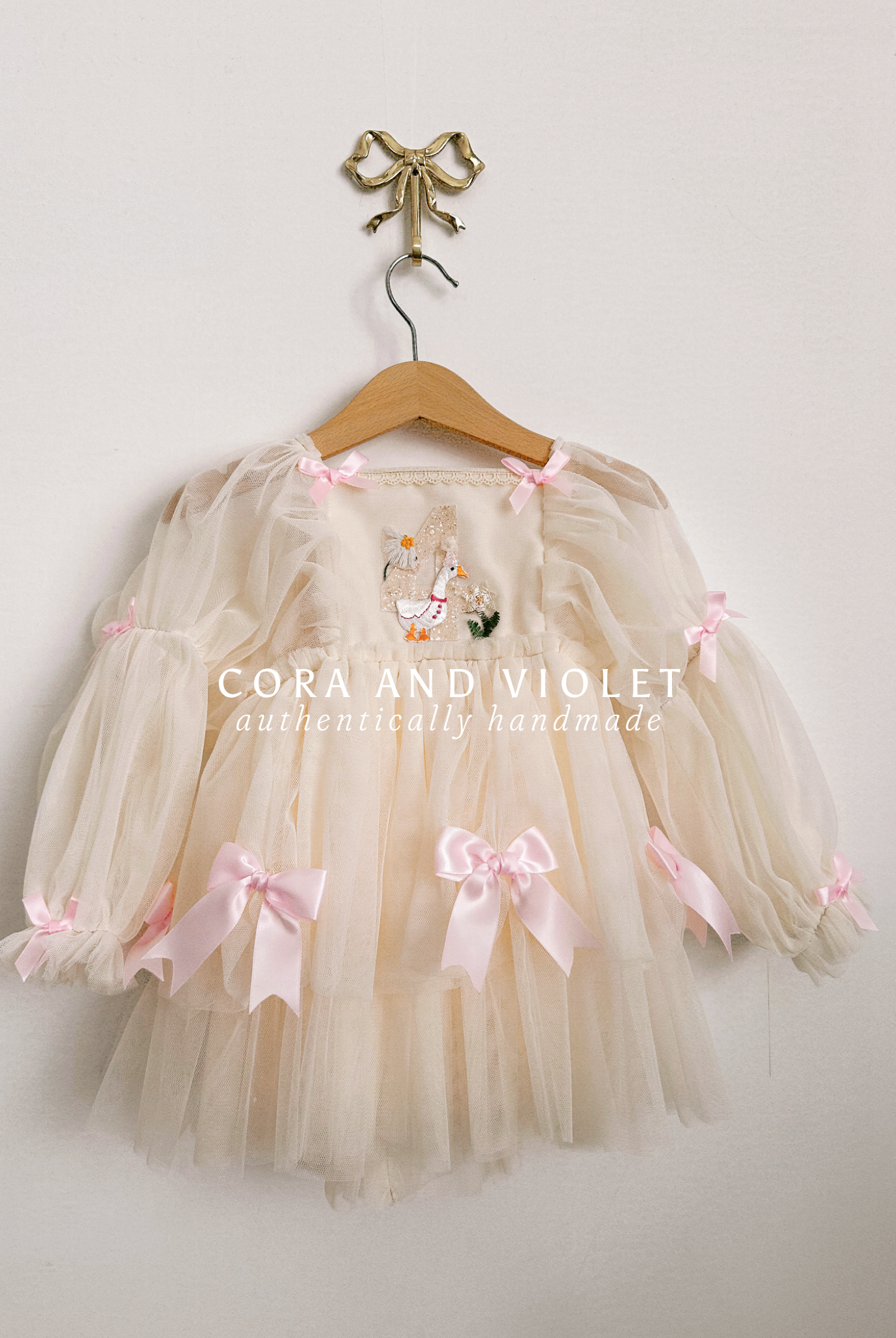 Hand-stitched luxury Silly Goose birthday dress for toddlers, featuring artisanal embroidery and heirloom construction by Cora and Violet.