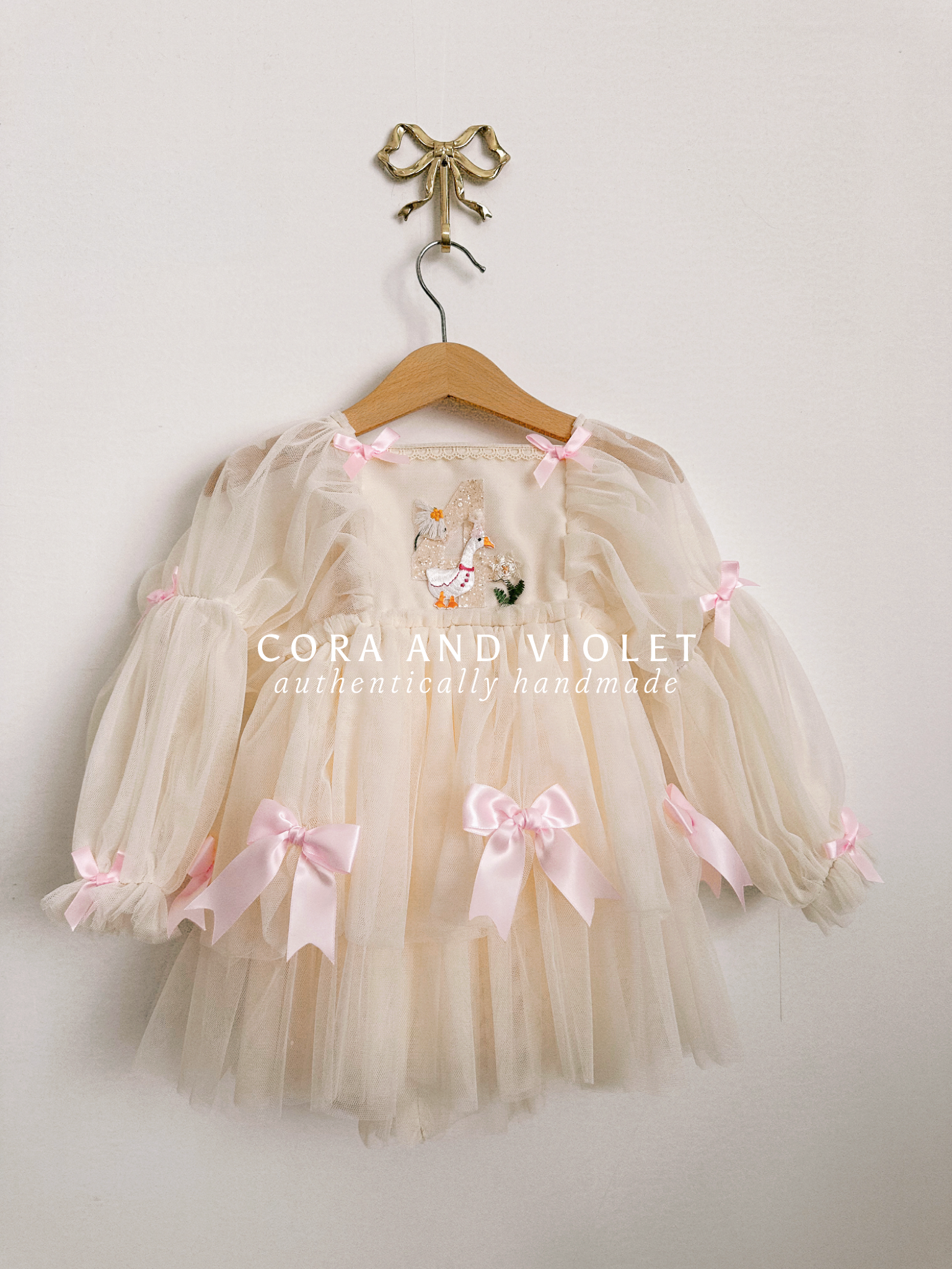 Hand-stitched luxury Silly Goose birthday dress for toddlers, featuring artisanal embroidery and heirloom construction by Cora and Violet.