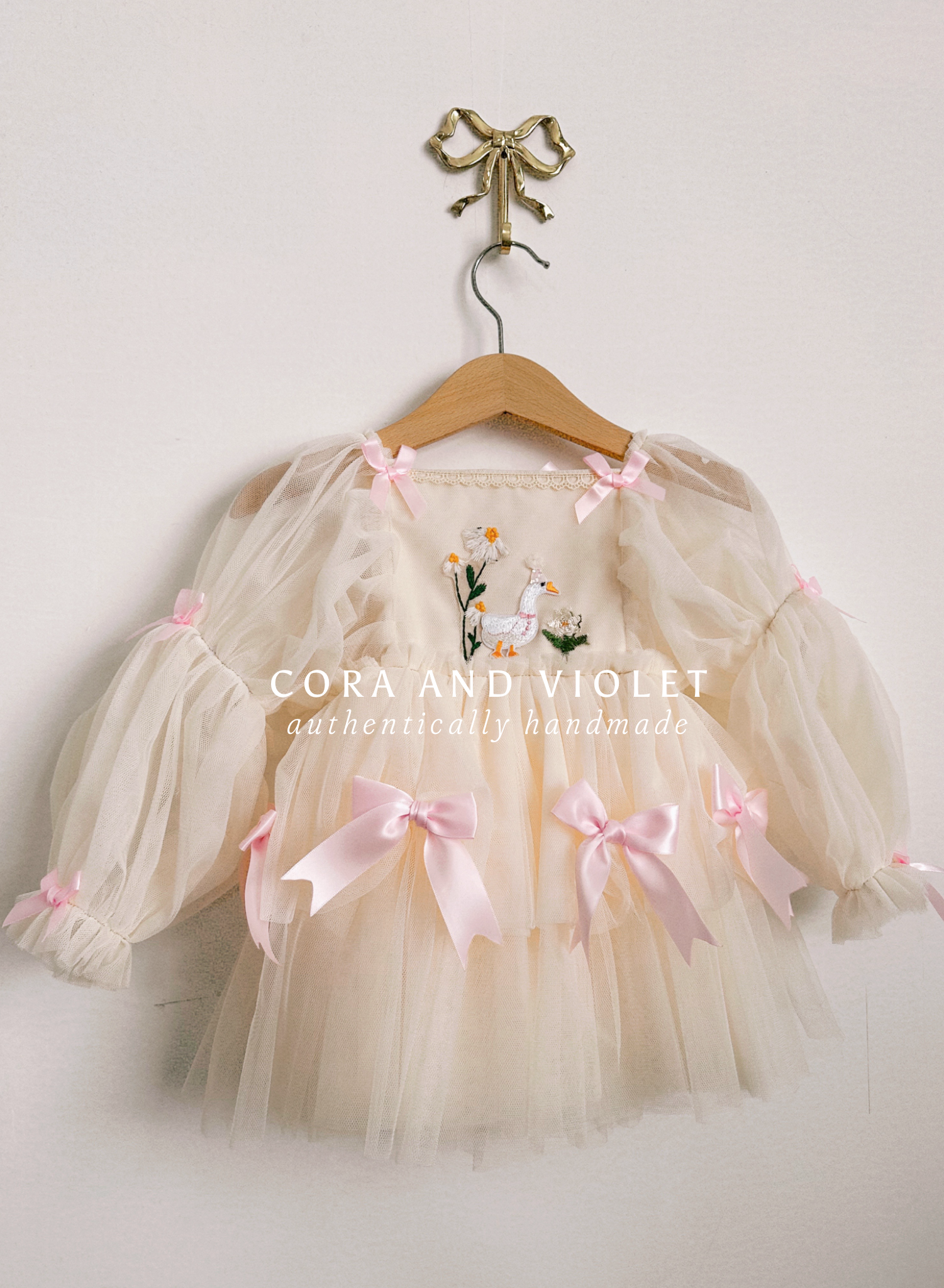 Hand-stitched luxury Silly Goose birthday dress for toddlers, featuring artisanal embroidery and heirloom construction by Cora and Violet.
