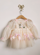 Hand-stitched luxury Silly Goose birthday dress for toddlers, featuring artisanal embroidery and heirloom construction by Cora and Violet.