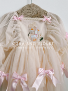 Hand-stitched luxury Silly Goose birthday dress for toddlers, featuring artisanal embroidery and heirloom construction by Cora and Violet.